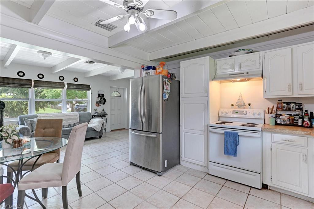 4391 Little Hickory Road Bonita Springs, FL 34134 - Photo 12 of 35 a kitchen with stainless steel appliances granite countertop a refrigerator and a stove top oven
