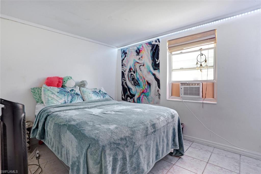 4391 Little Hickory Road Bonita Springs, FL 34134 - Photo 15 of 35 a bedroom with a bed and a window