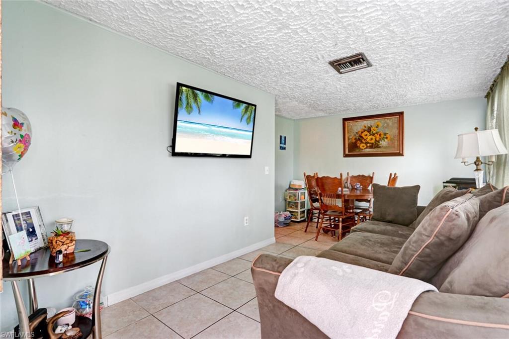 4391 Little Hickory Road Bonita Springs, FL 34134 - Photo 18 of 35 a living room with furniture and a couch