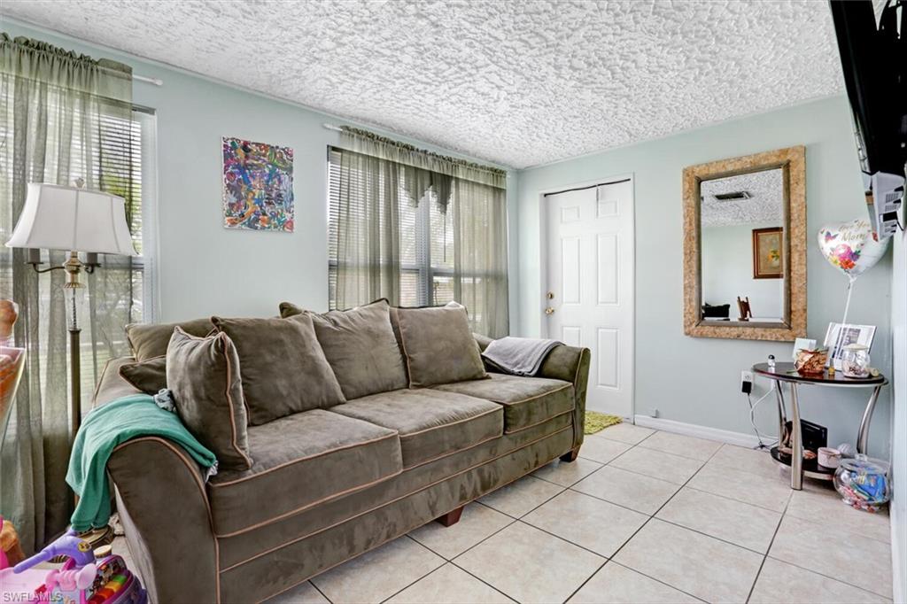 4391 Little Hickory Road Bonita Springs, FL 34134 - Photo 19 of 35 a living room with furniture and a flat screen tv