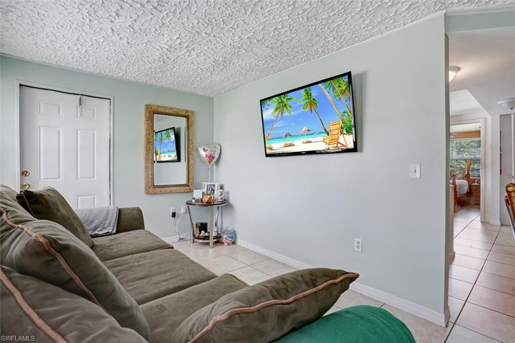 4391 Little Hickory Road Bonita Springs, FL 34134 - Photo 20 of 35 a bed room with a bed and a painting on the wall