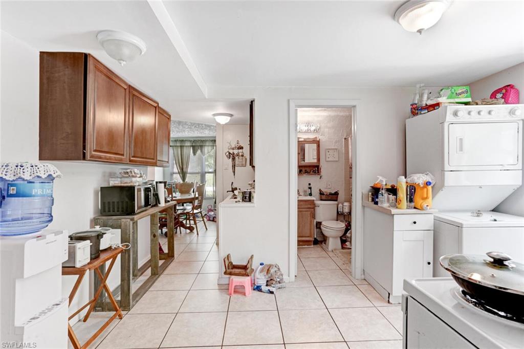 4391 Little Hickory Road Bonita Springs, FL 34134 - Photo 23 of 35 a room with furniture a flat screen tv and kitchen view