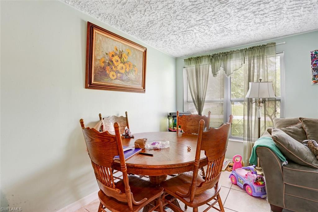 4391 Little Hickory Road Bonita Springs, FL 34134 - Photo 24 of 35 a dining room with furniture and a potted plants