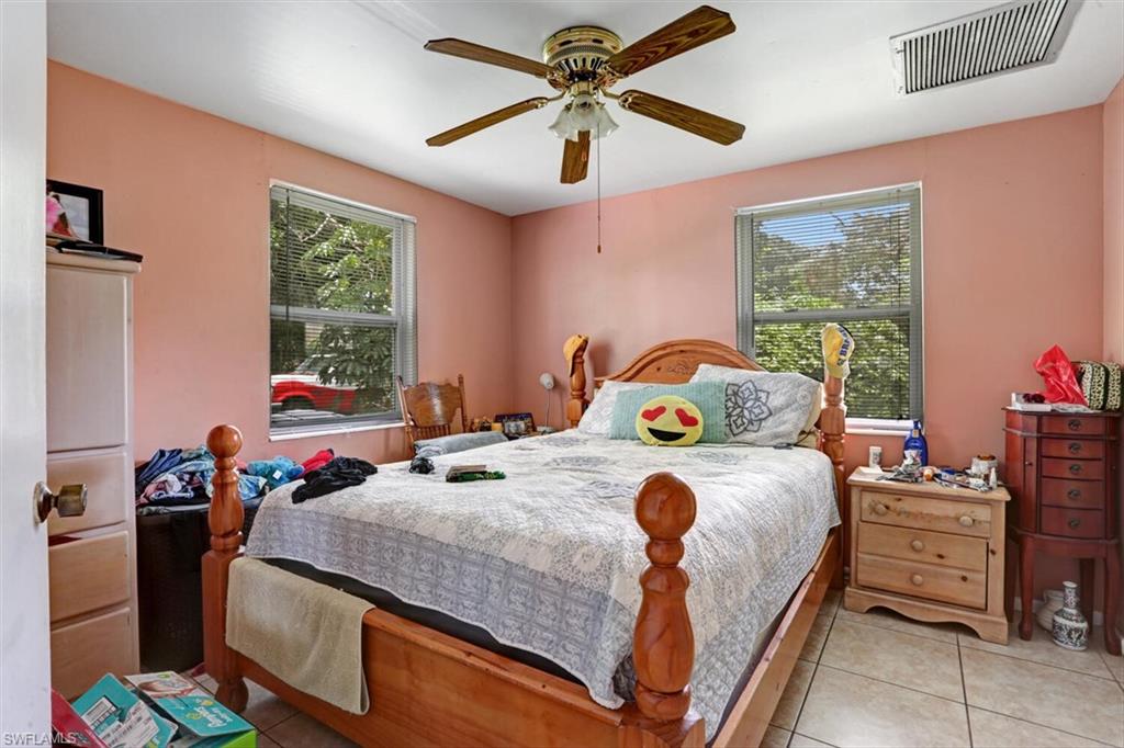 4391 Little Hickory Road Bonita Springs, FL 34134 - Photo 25 of 35 a bedroom with a bed and windows