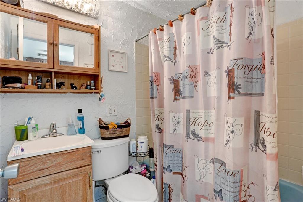 4391 Little Hickory Road Bonita Springs, FL 34134 - Photo 26 of 35 a bathroom with a sink toilet vanity and shower