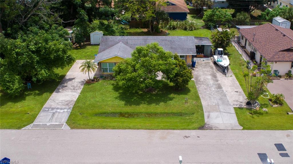 4391 Little Hickory Road Bonita Springs, FL 34134 - Photo 28 of 35 an aerial view of multiple houses with yard