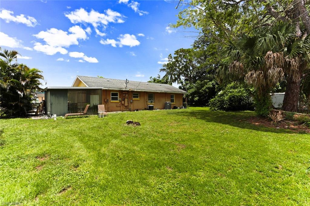 4391 Little Hickory Road Bonita Springs, FL 34134 - Photo 29 of 35 a front view of house with yard and green space