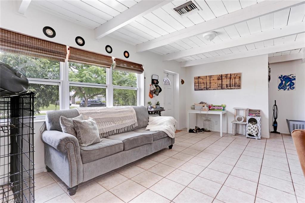 4391 Little Hickory Road Bonita Springs, FL 34134 - Photo 7 of 35 a living room with furniture and large windows