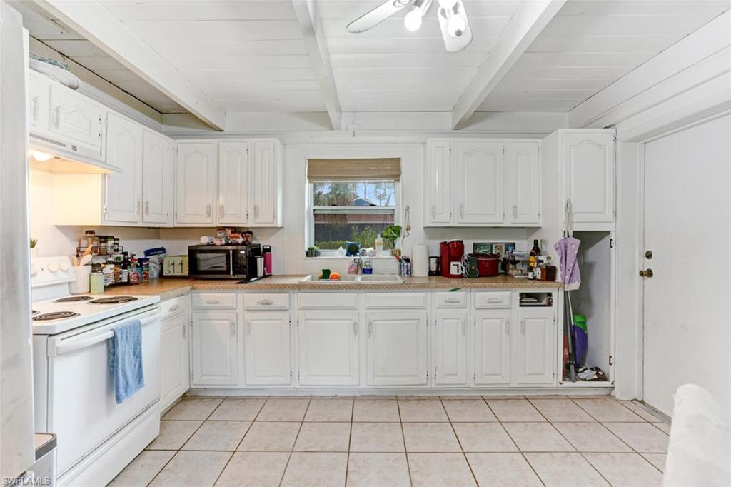 4391 Little Hickory Road Bonita Springs, FL 34134 - Photo 9 of 35 a kitchen with cabinets and window
