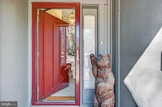 a living room with furniture a rug and a lamp