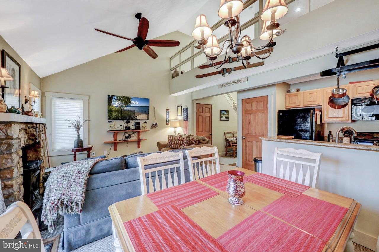 390 Snow Ridge Cir Lake Lake Harmony, PA 18624 - Photo 22 of 60 a dining room with wooden floor a chandelier a wooden table and chairs