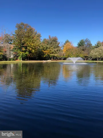 a view of a dining room with furniture a chandelier and wooden floor