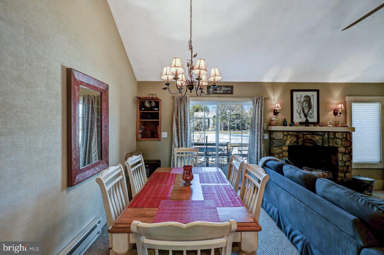 390 Snow Ridge Cir Lake Lake Harmony, PA 18624 - Photo 33 of 60 a view of a dining room with furniture a chandelier and wooden floor
