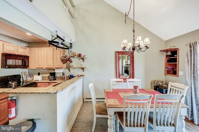 a bathroom with a granite countertop toilet sink and mirror