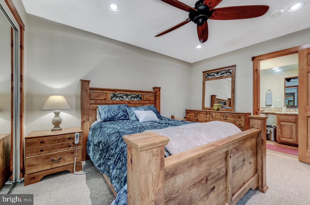 390 Snow Ridge Cir Lake Lake Harmony, PA 18624 - Photo 47 of 60 a bed room with a bed and a chandelier