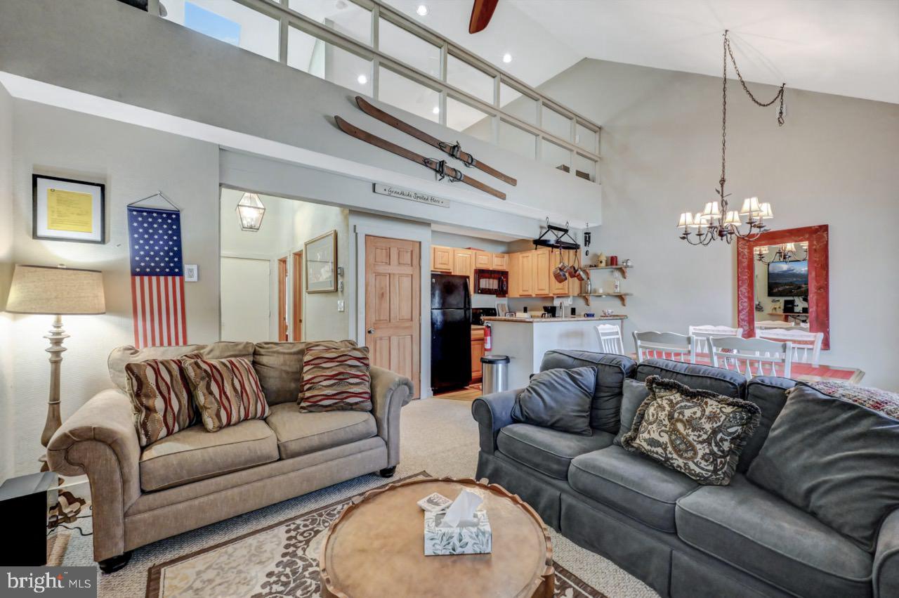 390 Snow Ridge Cir Lake Lake Harmony, PA 18624 - Photo 7 of 60 a living room with furniture and a chandelier