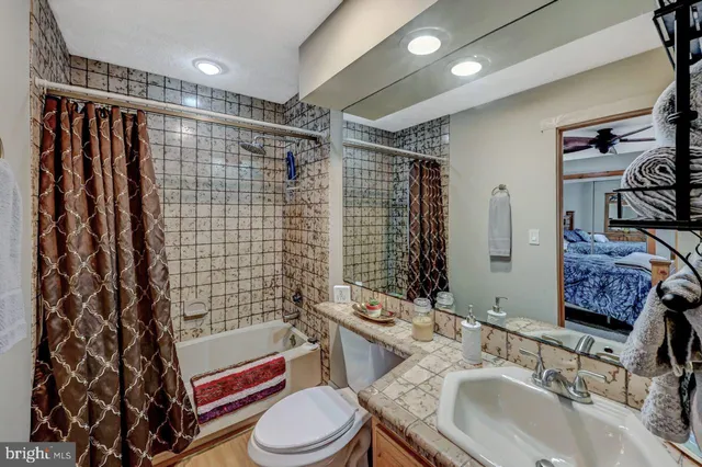 a bedroom with a bed and a dresser with mirror