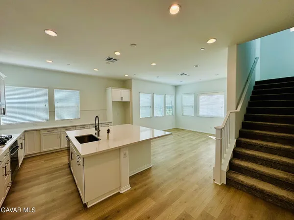 a kitchen with sink refrigerator and outdoor view