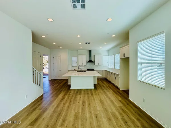 a large white kitchen with a large window