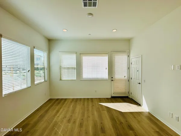 a view of a room with wooden floor and window