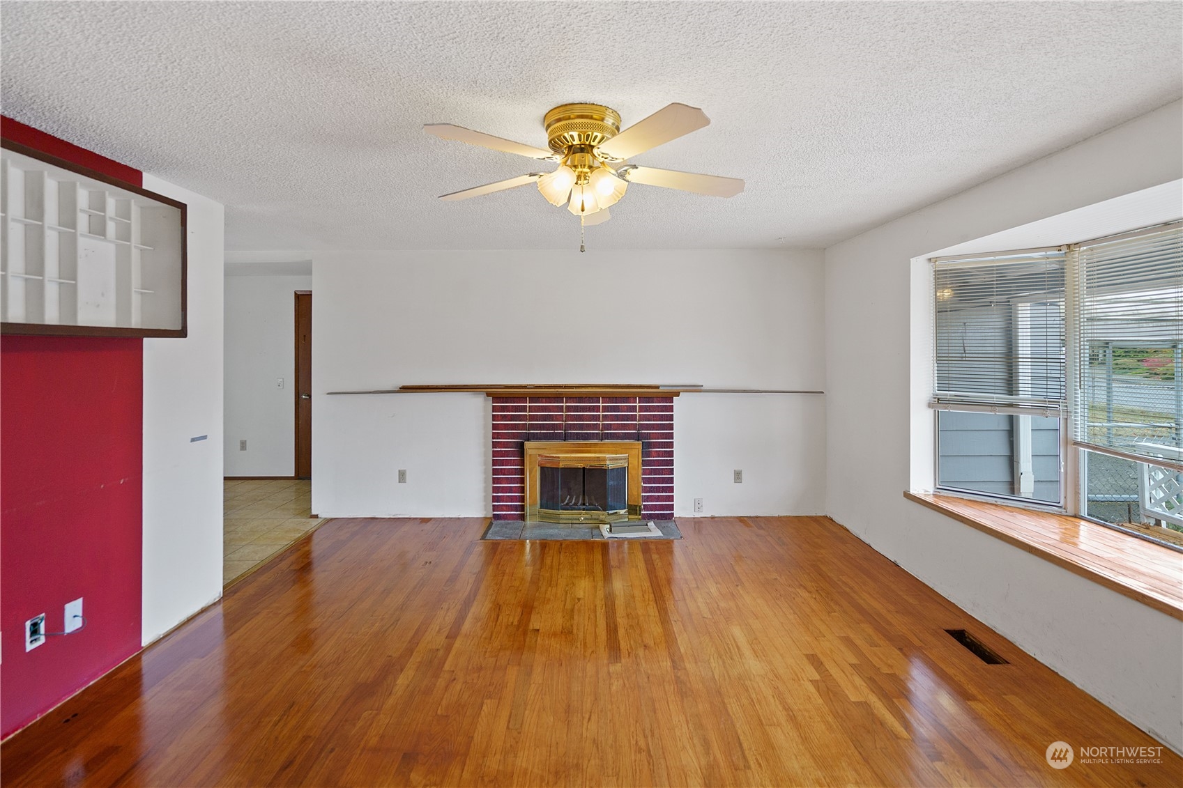16632 124th Avenue Southeast Renton, WA 98058 - Photo 4 of 29 a view of empty room with wooden floor and fan