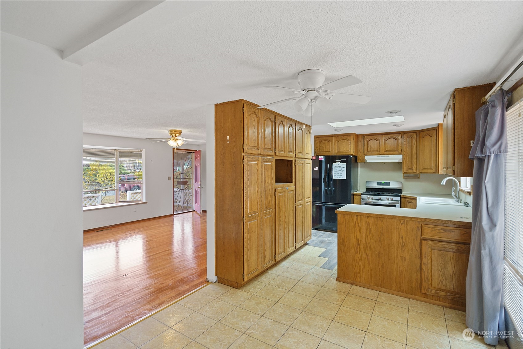 16632 124th Avenue Southeast Renton, WA 98058 - Photo 6 of 29 a kitchen with stainless steel appliances granite countertop a refrigerator and a sink