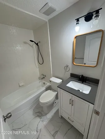 a kitchen with stainless steel appliances kitchen island a sink and wooden floor
