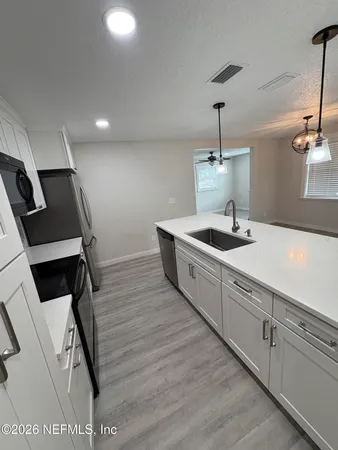 a room with a stove and cabinets