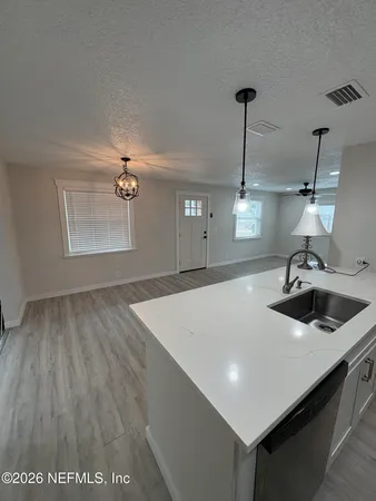 a kitchen with white cabinets and black appliances
