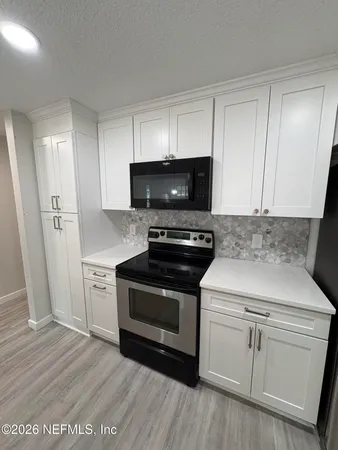 a view of hallway with wooden floor