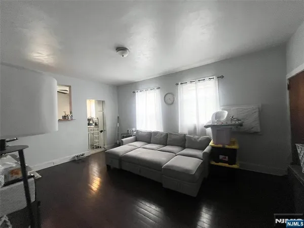 a living room with furniture window and wooden floor