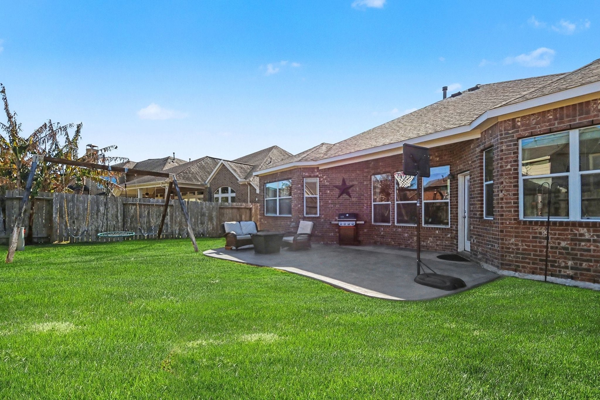 27006 Cliff Pointe Lane Katy, TX 77494 - Photo 33 of 34 Fully fenced backyard with open green space and patio—providing privacy, versatility, and room to enjoy the outdoors year-round.