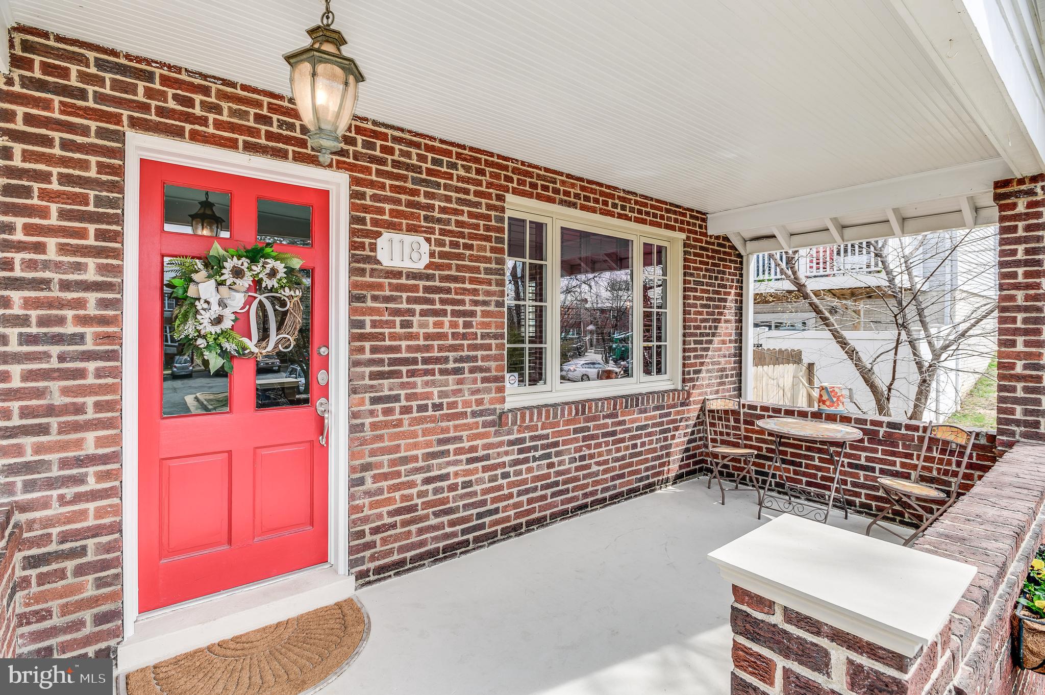 Open Porch with Charming Red Front Door