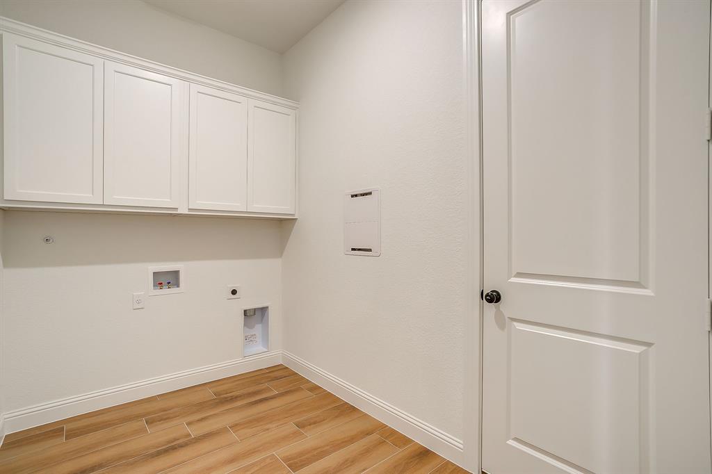7286 Velvetleaf Street Benbrook, TX 76126 - Photo 13 of 39 a view of storage and utility room with wooden floor