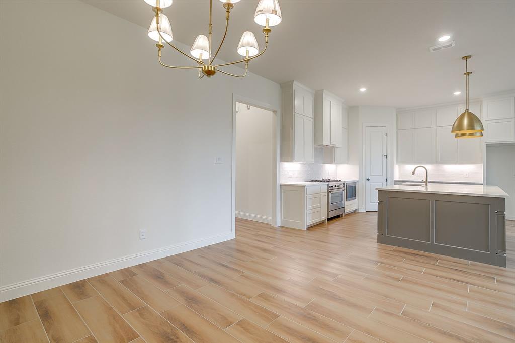 7286 Velvetleaf Street Benbrook, TX 76126 - Photo 15 of 39 a view of a kitchen with furniture and wooden floor