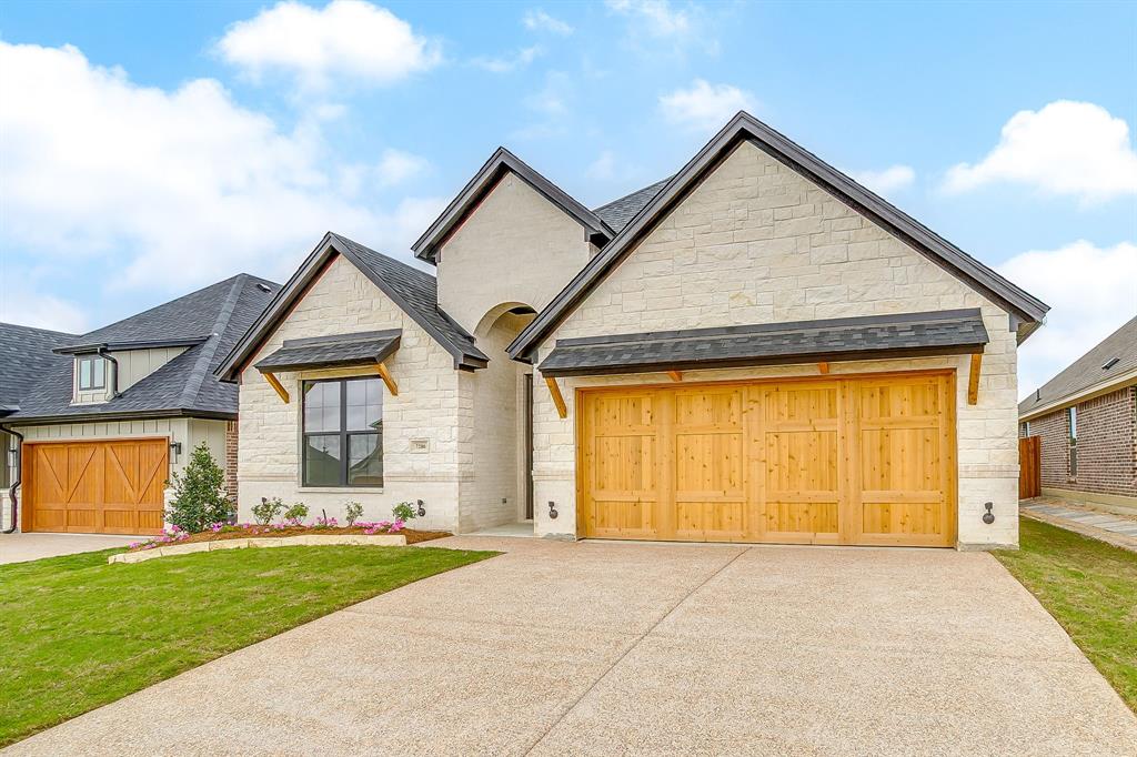 7286 Velvetleaf Street Benbrook, TX 76126 - Photo 2 of 39 a front view of a house with a yard and garage