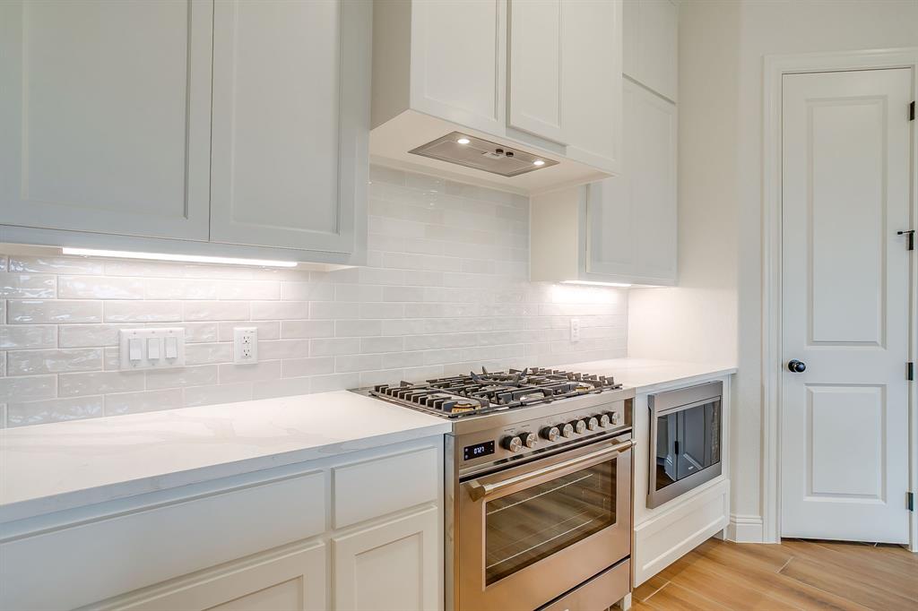 7286 Velvetleaf Street Benbrook, TX 76126 - Photo 22 of 39 a kitchen with stainless steel appliances granite countertop white cabinets and a stove
