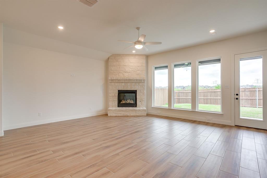 7286 Velvetleaf Street Benbrook, TX 76126 - Photo 23 of 39 a view of an empty room with wooden floor and a window