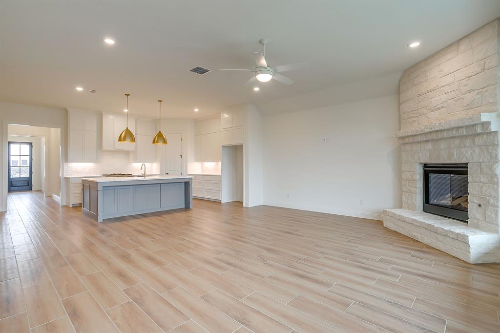 7286 Velvetleaf Street Benbrook, TX 76126 - Photo 24 of 39 a view of open kitchen with a sink and a fireplace
