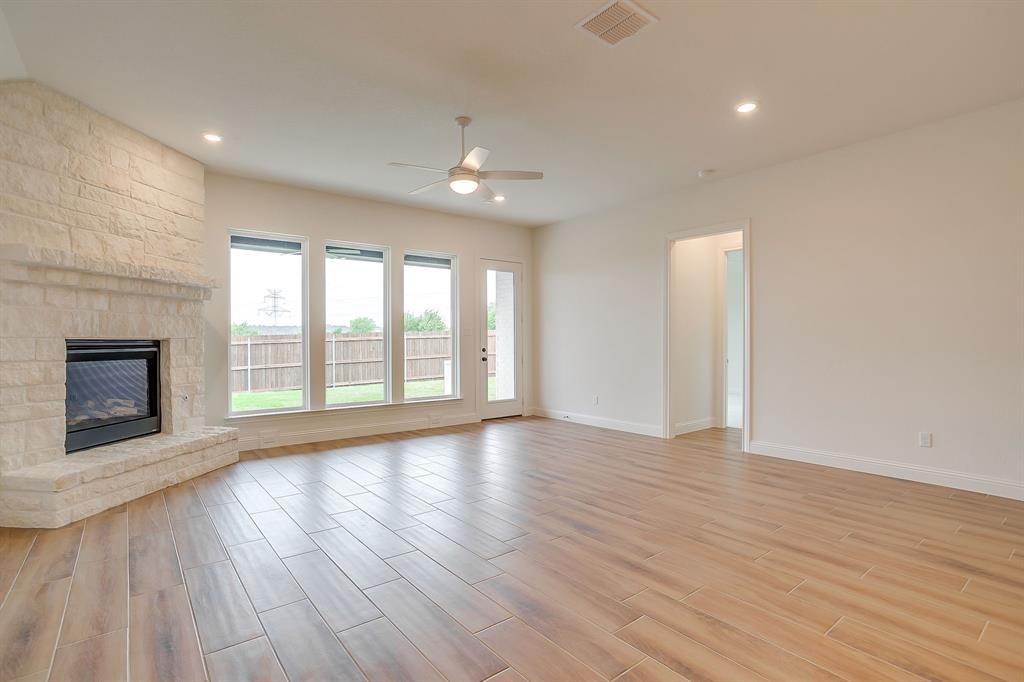 7286 Velvetleaf Street Benbrook, TX 76126 - Photo 25 of 39 a view of an empty room with wooden floor and a window