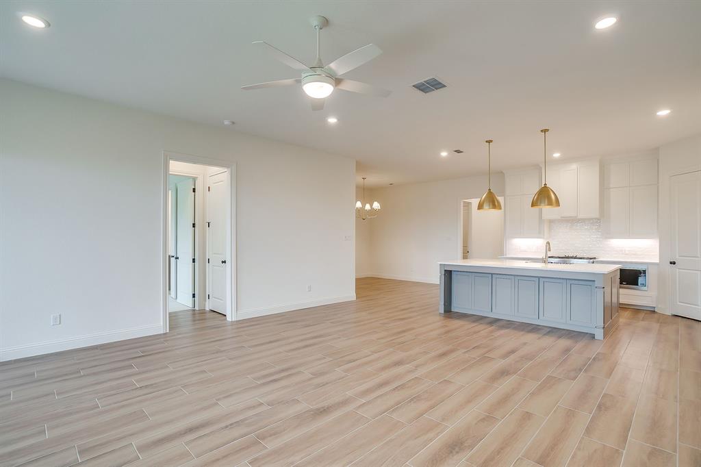 7286 Velvetleaf Street Benbrook, TX 76126 - Photo 26 of 39 a kitchen with a sink cabinets and wooden floor