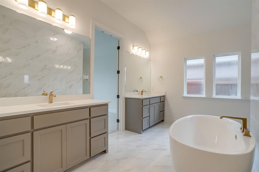 7286 Velvetleaf Street Benbrook, TX 76126 - Photo 30 of 39 a bathroom with a tub sink and mirror