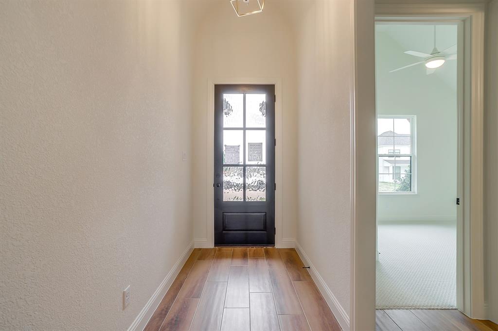 7286 Velvetleaf Street Benbrook, TX 76126 - Photo 5 of 39 a view of hallway with window and wooden floor