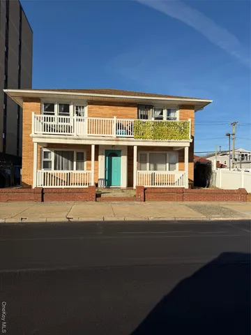 a front view of a building with a garden
