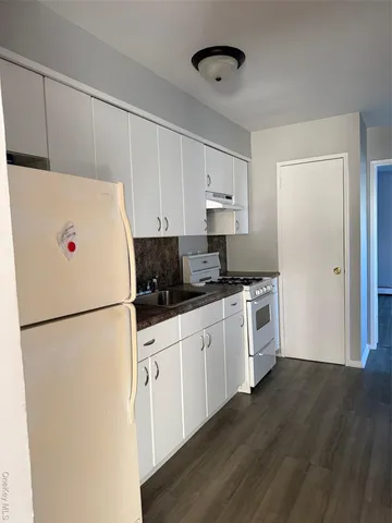 a white refrigerator freezer sitting in a kitchen