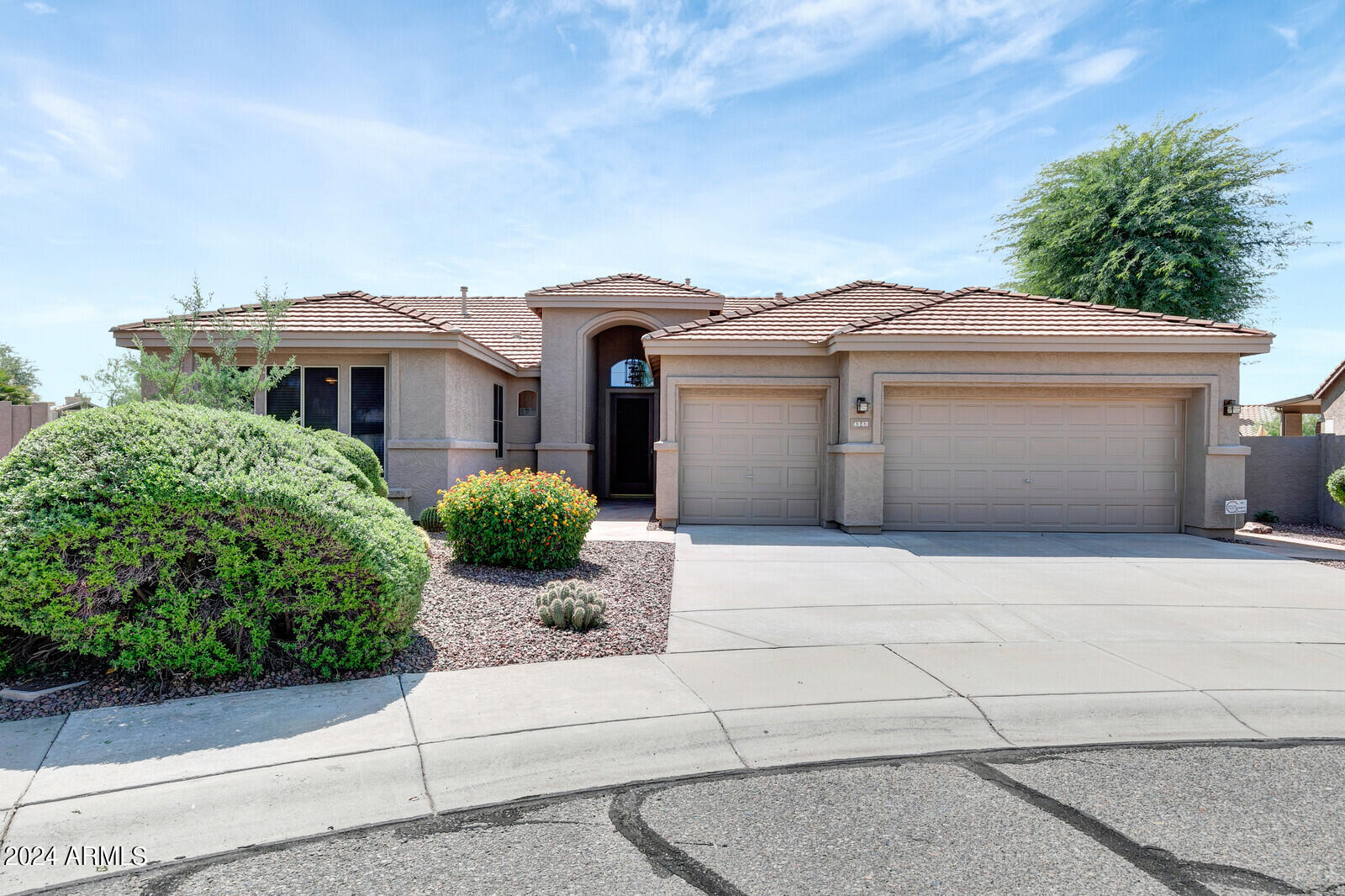a front view of a house with garage