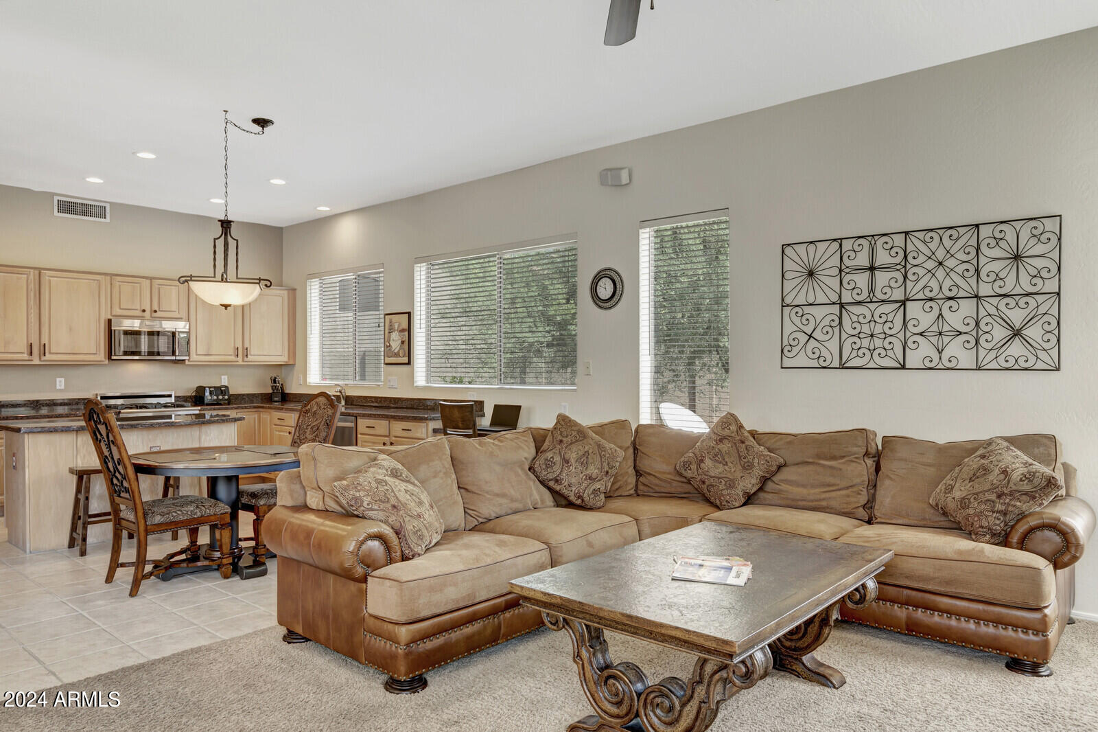 4343 East Mossman Drive Phoenix, AZ 85050 - Photo 12 of 36 a living room with furniture a large window and a chandelier