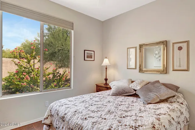 a large bed sitting in a bedroom next to a lamp