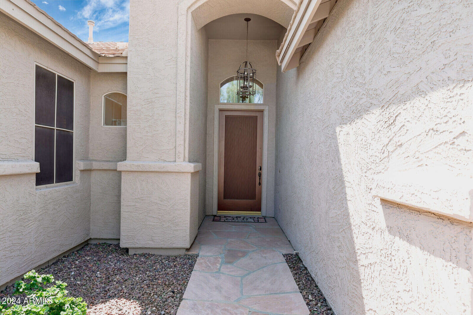 4343 East Mossman Drive Phoenix, AZ 85050 - Photo 2 of 36 a view of a hallway with wooden walls and door