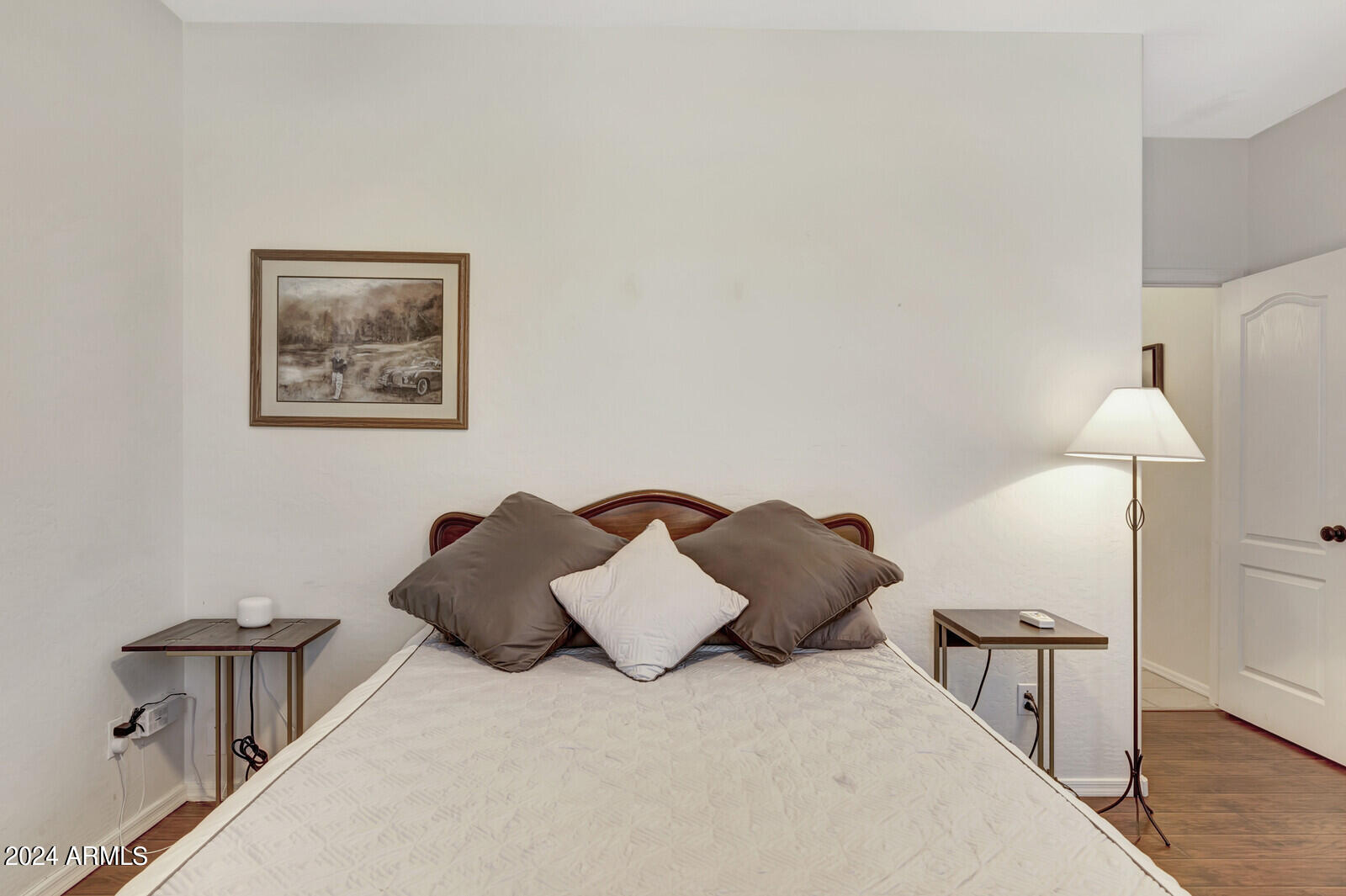 4343 East Mossman Drive Phoenix, AZ 85050 - Photo 21 of 36 a large bed sitting in a bedroom next to a lamp